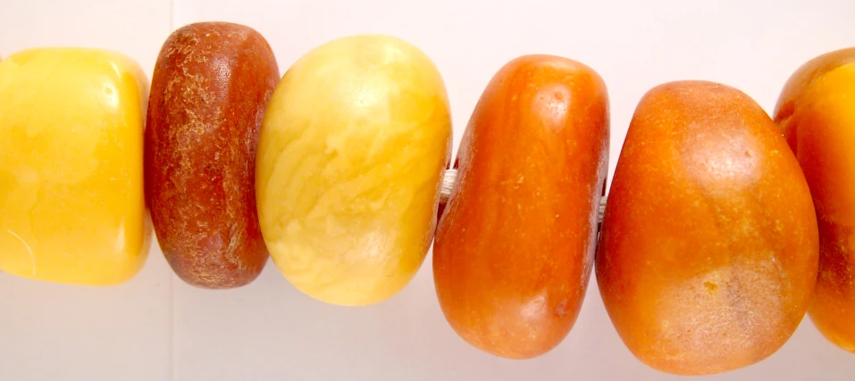 five donuts in different shades on a white surface