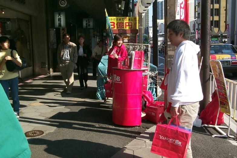 some people are standing on the street talking to someone