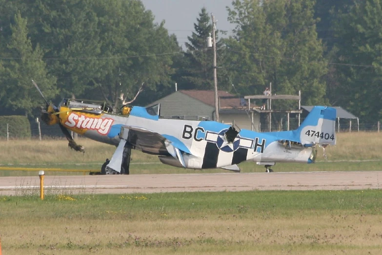 an older propeller plane sitting on the tarmac