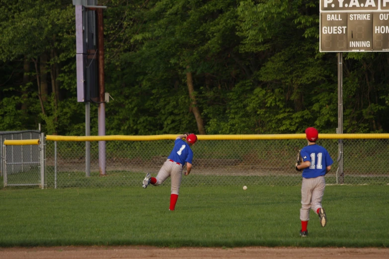 baseball players playing baseball on a green field