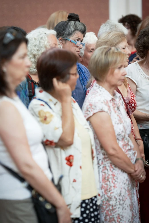 a group of women are standing in a room