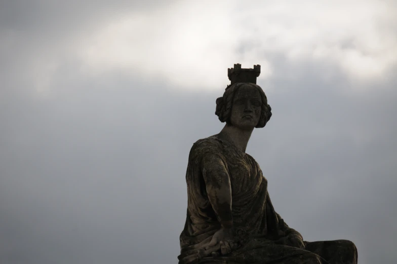 a statue of queen mary is in a pose for a picture