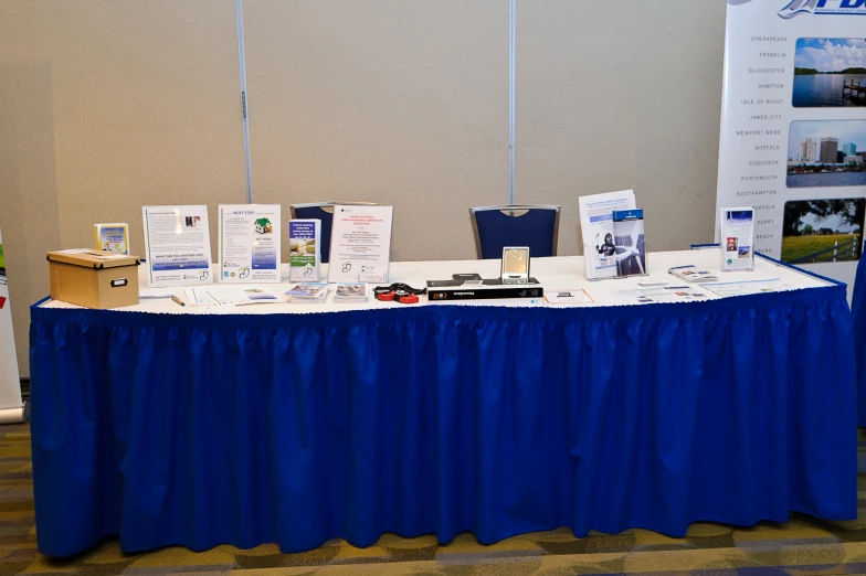 table with several signs and posters at exhibit