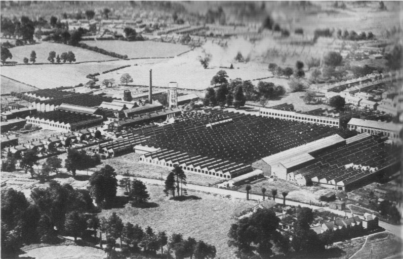 an aerial view of a building in the woods