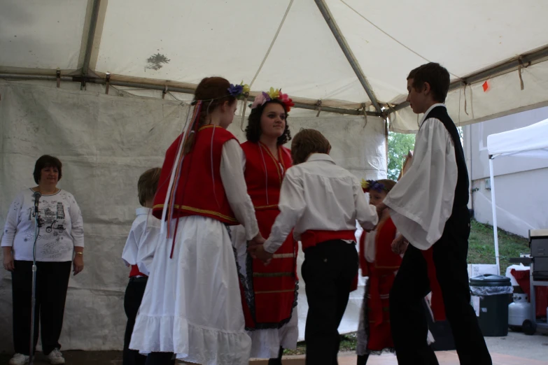 a group of women in traditional german dress holding hands