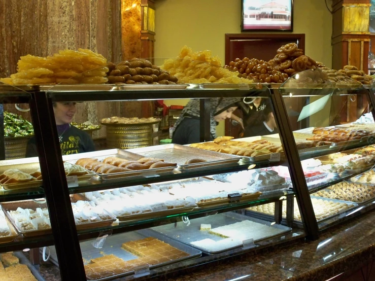 several pastry cases line the counter of a restaurant