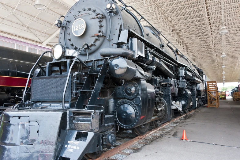 a large black train sitting inside of a garage