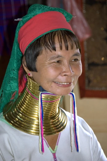 the woman is smiling for the camera while wearing a neck piece
