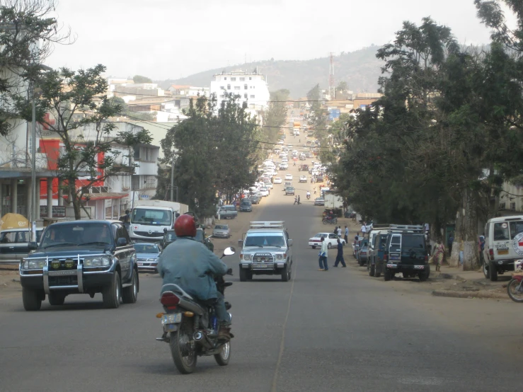 a man is riding his motorcycle down the street