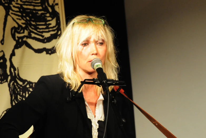 the woman is speaking at a public gathering