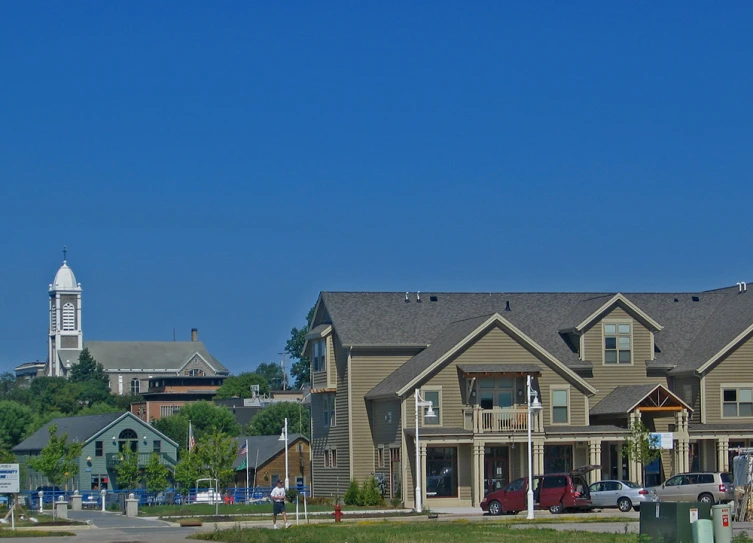 three large brown houses are situated beside some streetlights