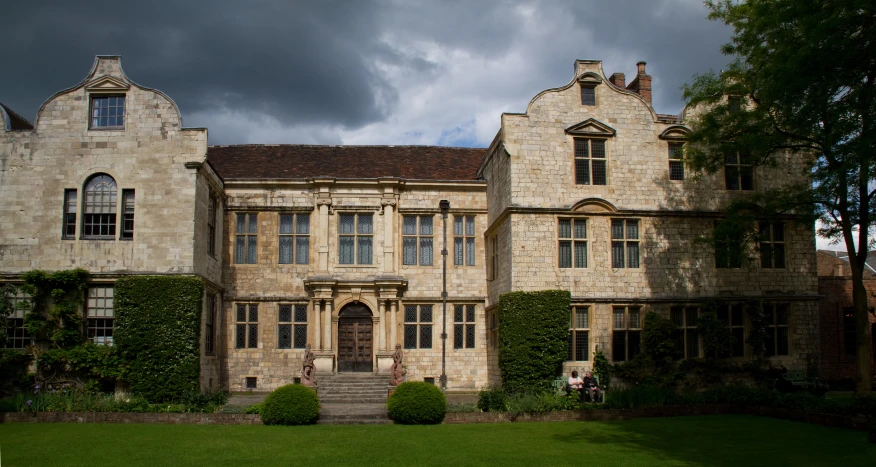 an image of a castle like building with hedges around it