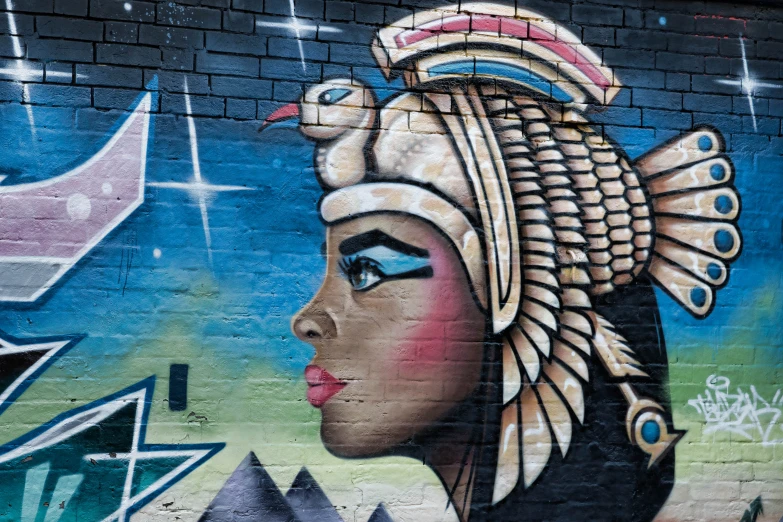 the wall has a large mural of a woman wearing an indian headdress