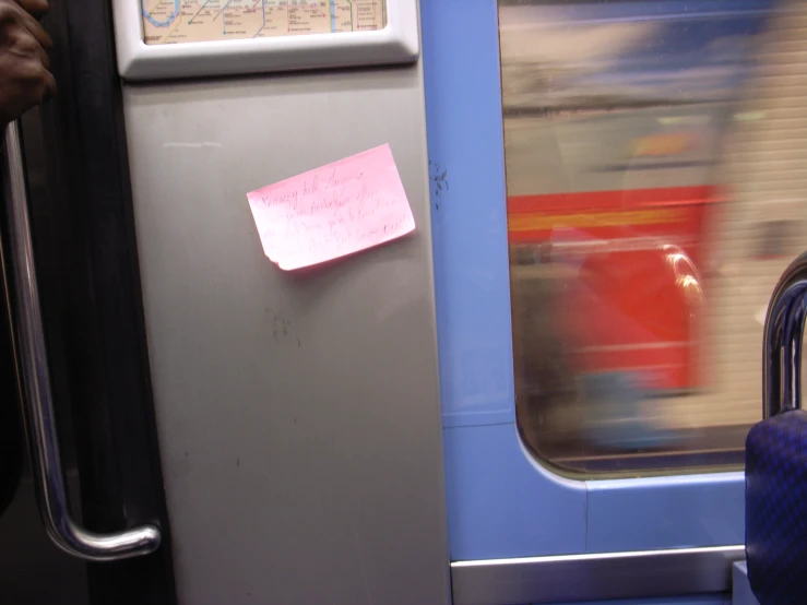 a bus door with a note attached to it