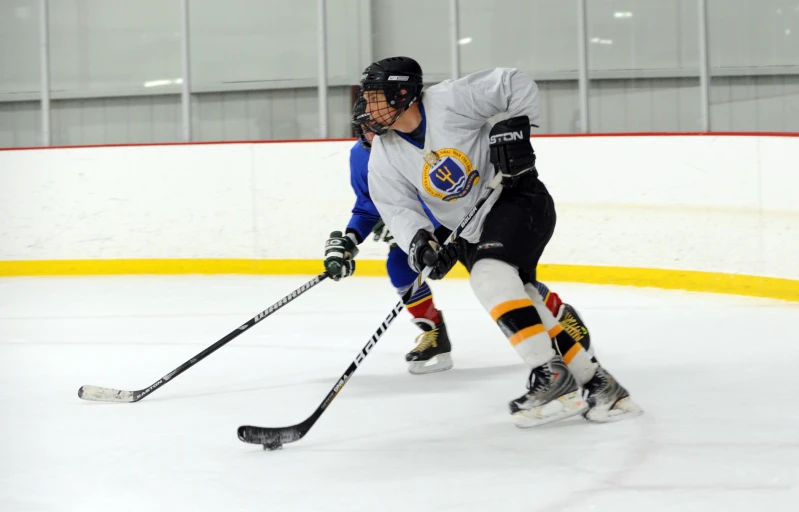 a hockey player running with the puck on the ice