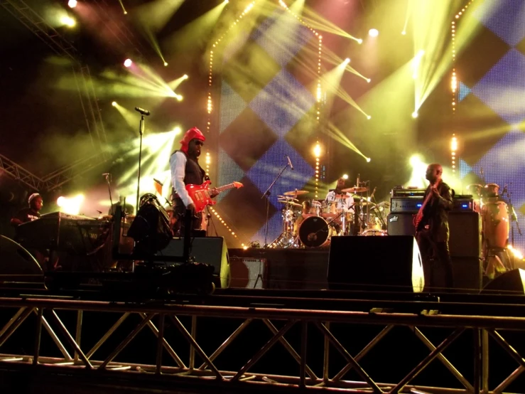 a band on stage with green and white lighting