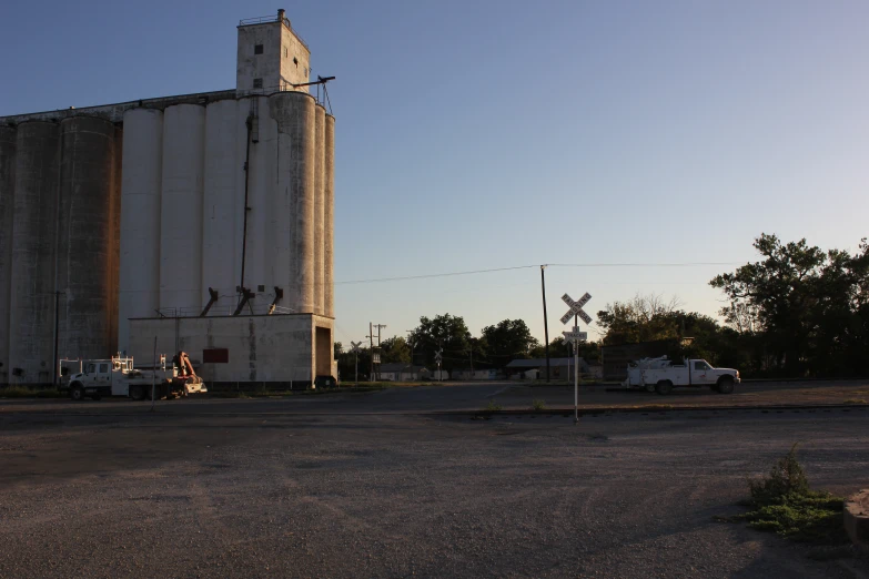 this image shows an industrial building with cars parked outside