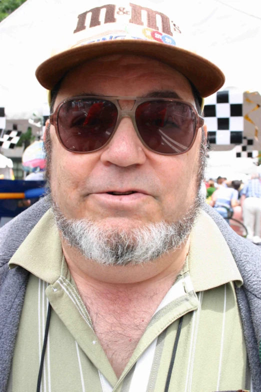 a man with a grey beard wearing glasses and a baseball cap