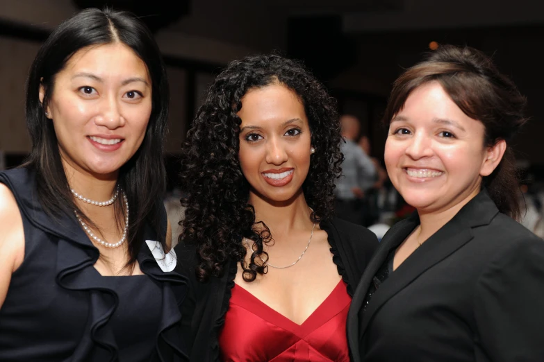 three women posing for a picture in a restaurant