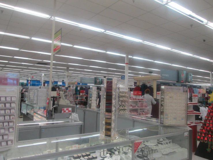 a woman stands next to the store front counter