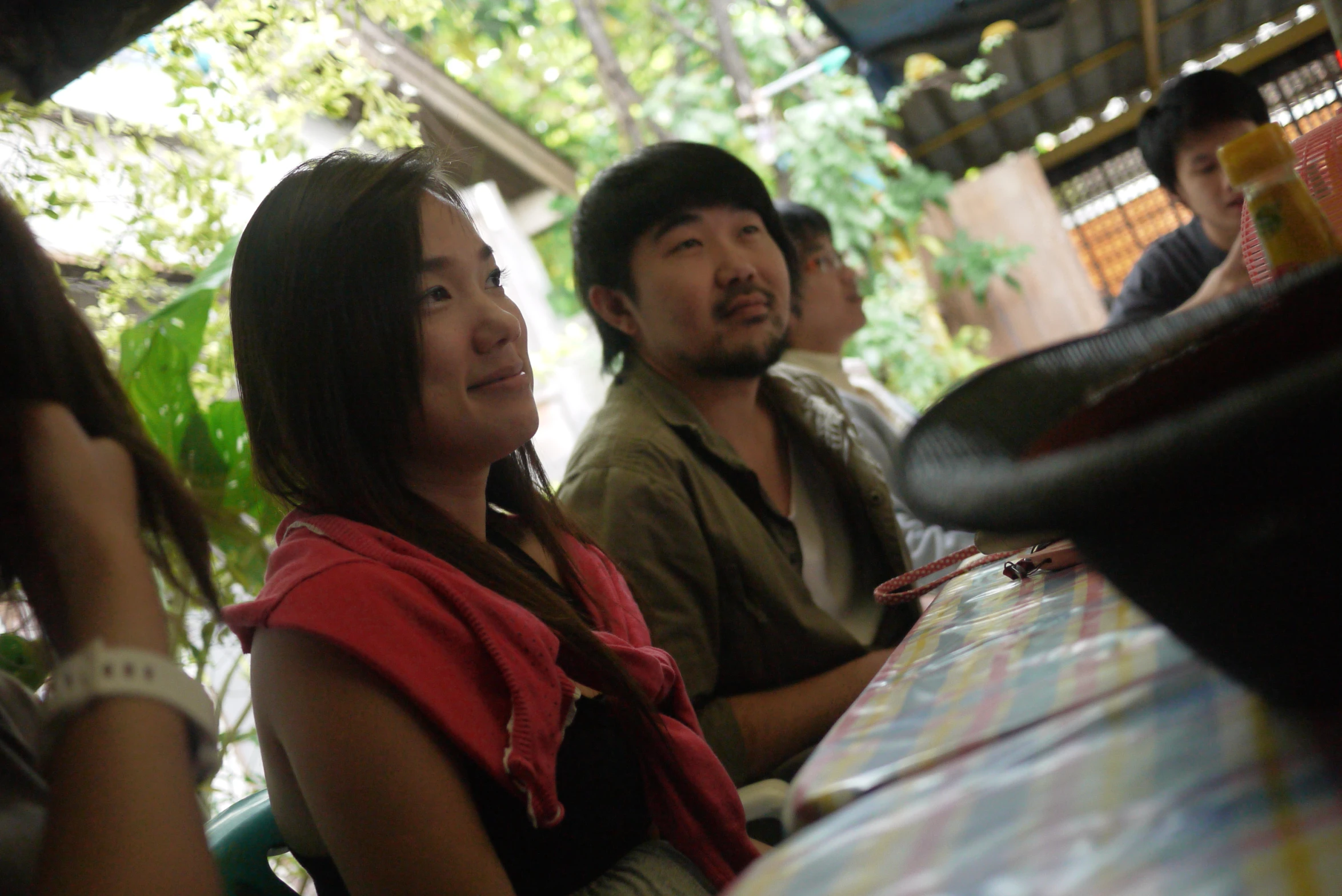 a man and woman sitting at a table with other people