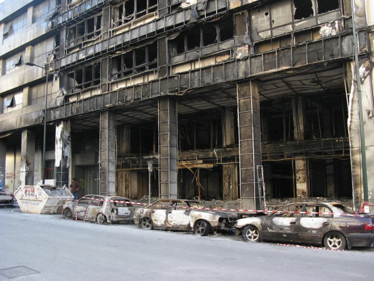 cars in front of an old building being renovated