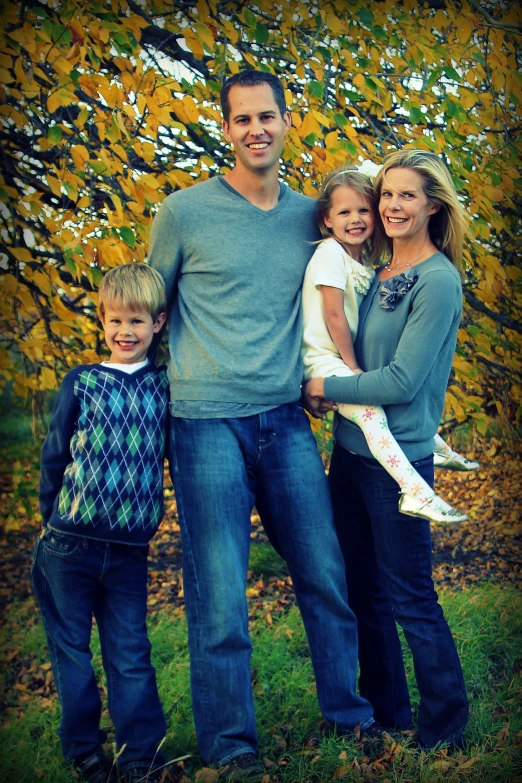 an image of two children and a woman posing for a family po