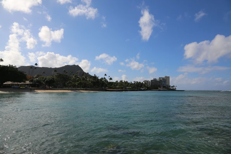 an island off the coast with very blue water