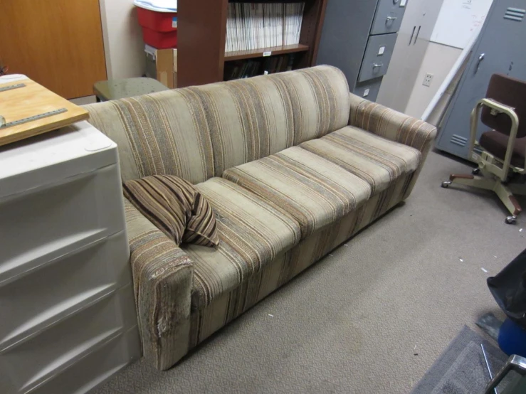 a long striped sofa in a big room