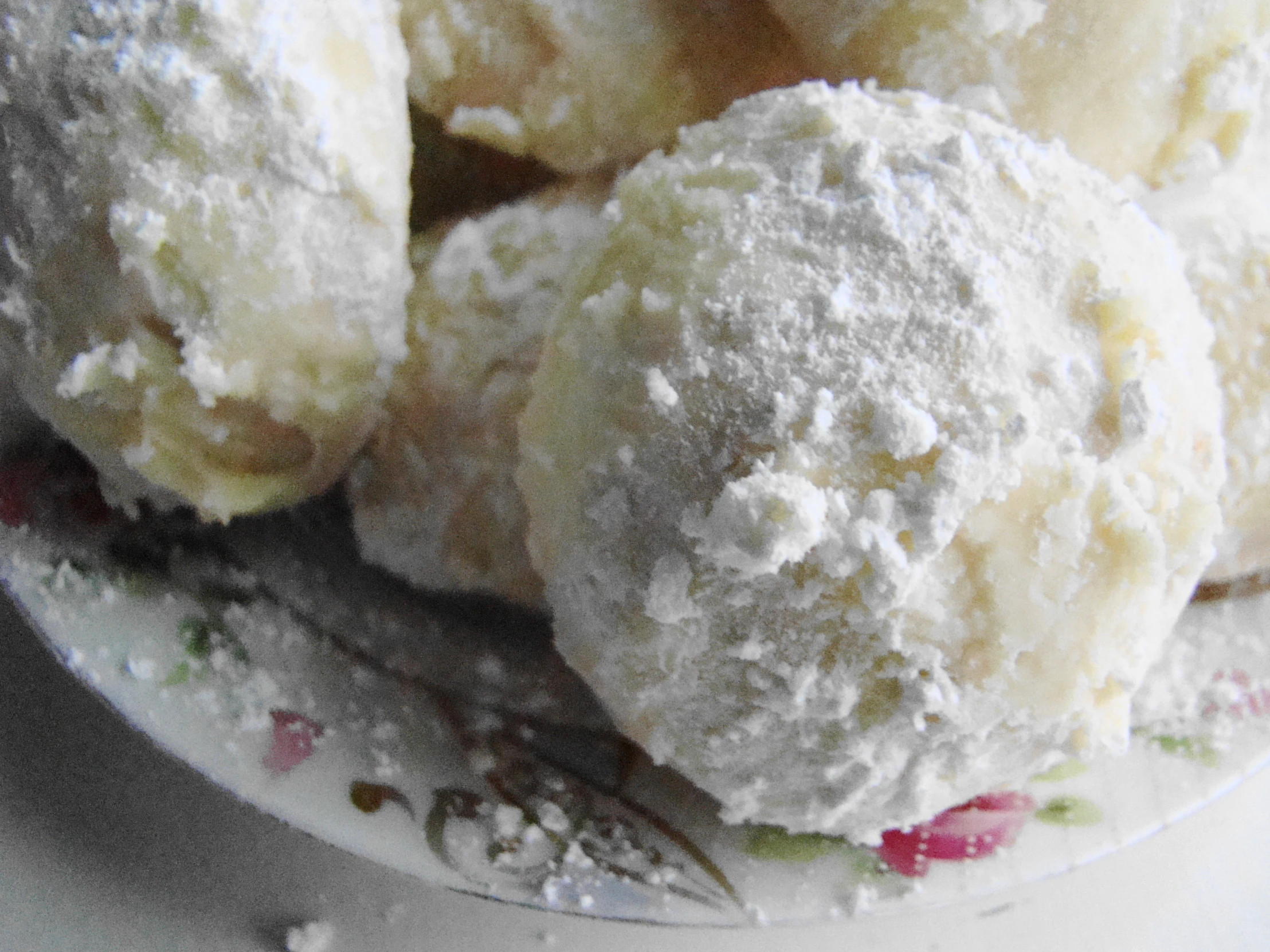 a plate filled with white sugar balls on top of a table