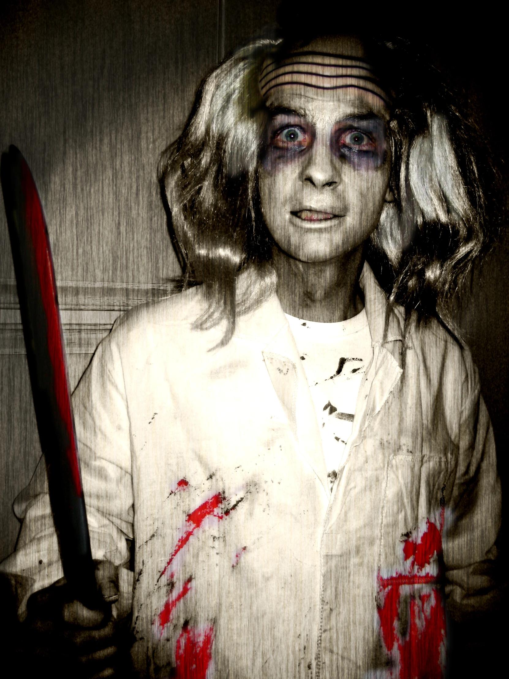 an elderly lady in zombie makeup and holding a baseball bat