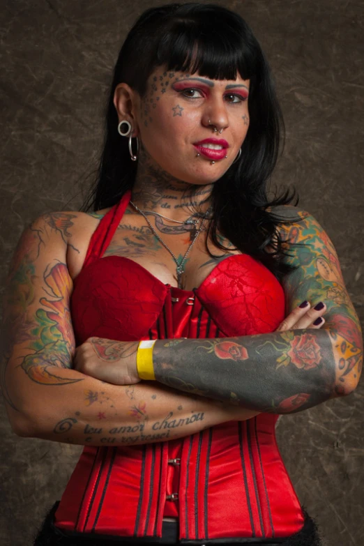 woman with many tattoos and red dress on