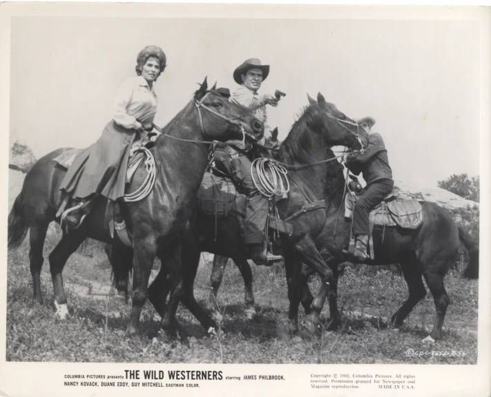 black and white pograph of men riding horses