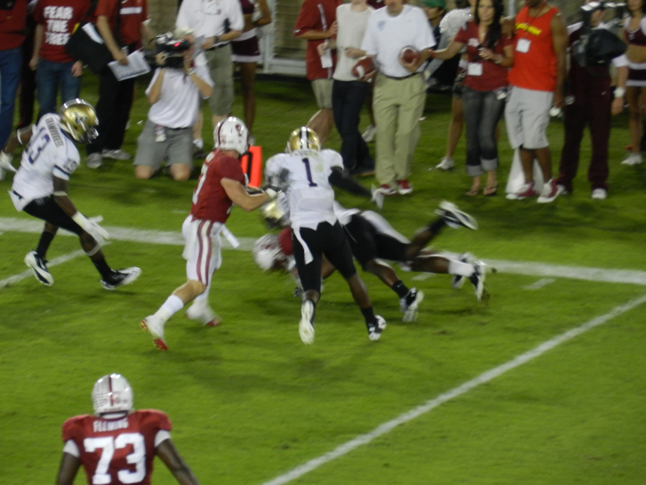 football players are running and being chased by other people