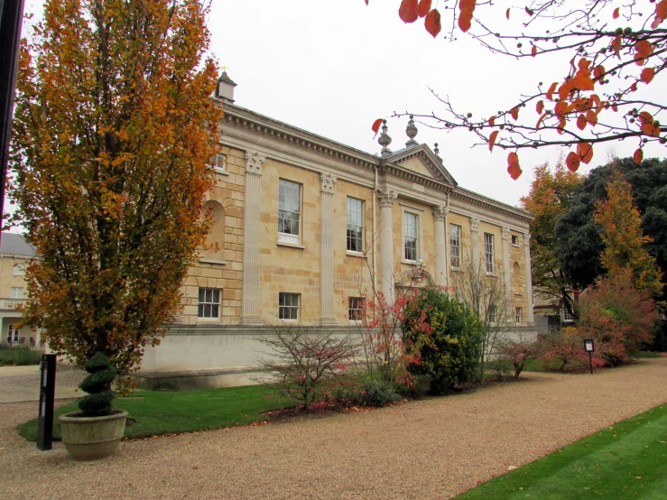 a large, two story, old building with some stone walkway in front