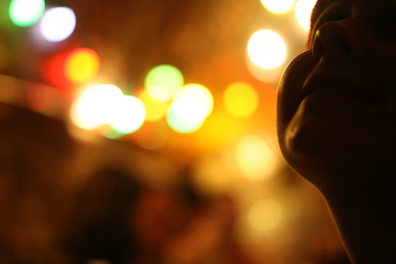 blurry pograph of a young person's head with a bright blurred background