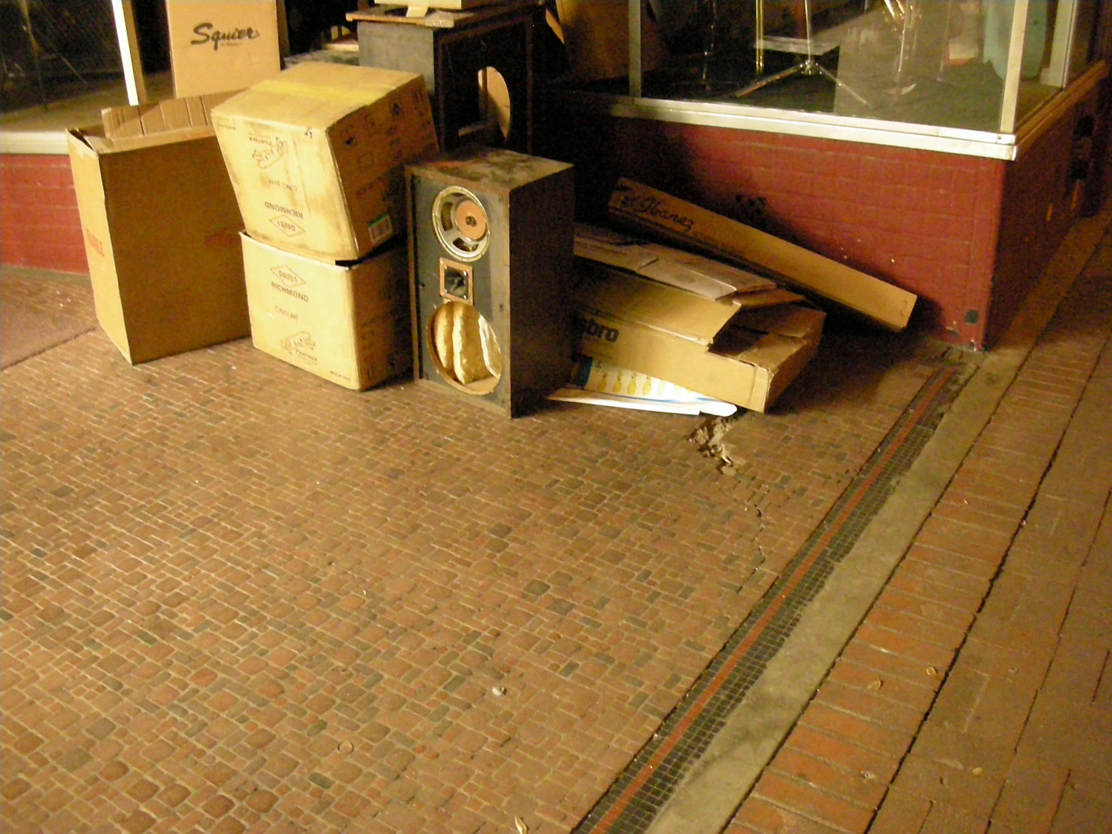 three boxes stacked on each other outside an empty store