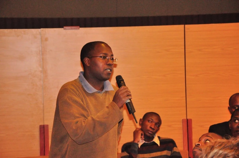 some men talking with microphones at a seminar