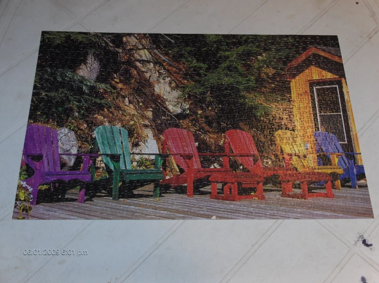 a bunch of colorful chairs sitting on a porch