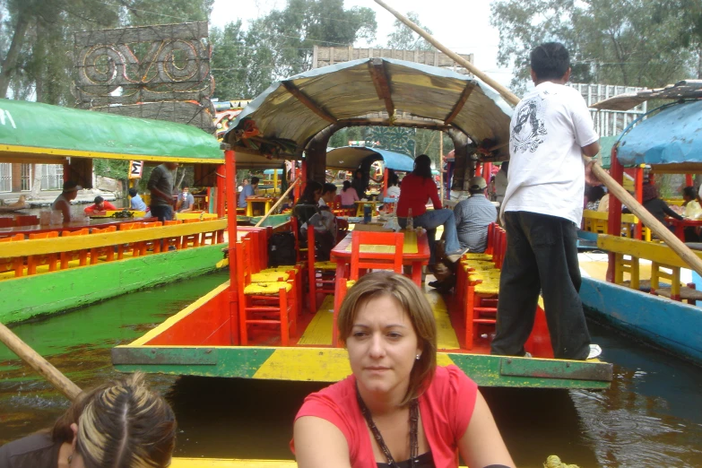 a group of people standing on top of colorful boat