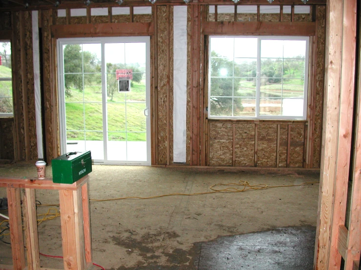 the interior of an unfinished house with windows and doors