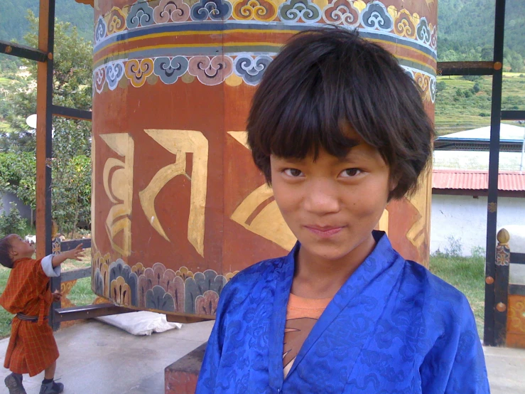 a boy that is standing in front of a structure