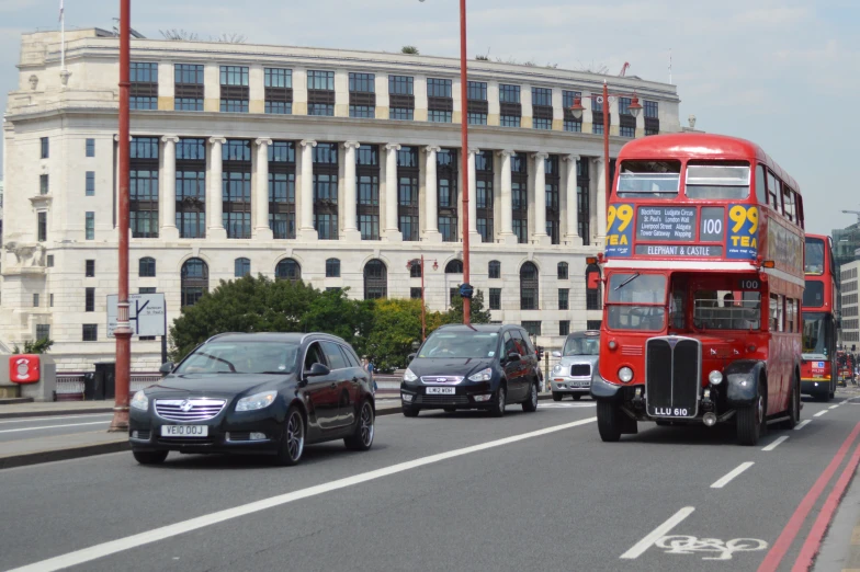 there are cars and buses driving along the street