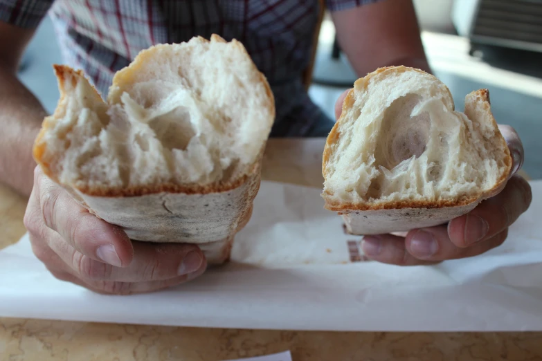 a person that is holding some kind of bread