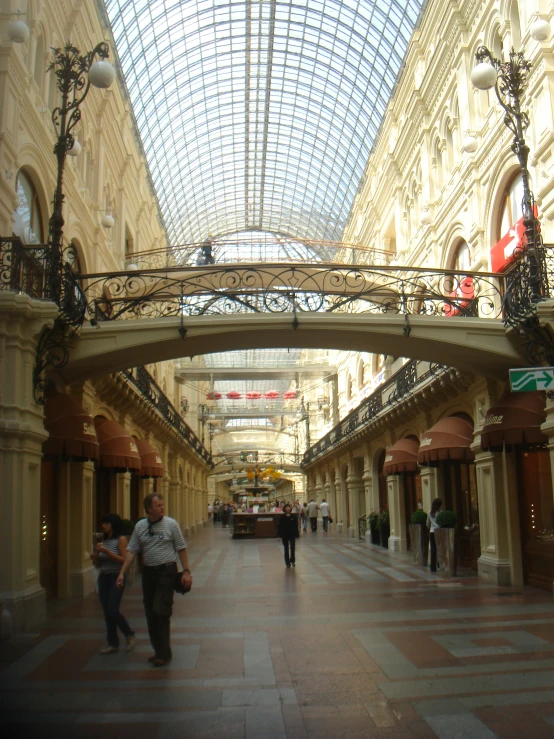 there are people walking down the middle of a shopping area