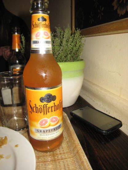 a bottle of sabor ferrotto sitting next to a cup on a table