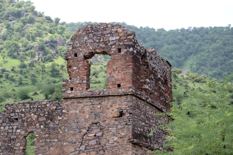 the ruins of an old church with a mountain in the background