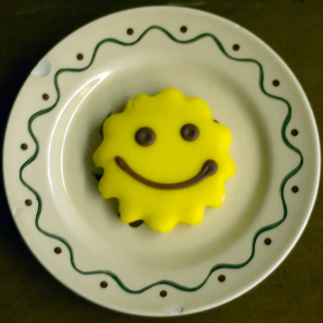 yellow and brown smiley face on white plate