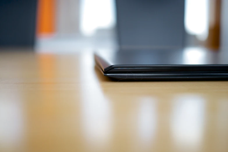 a remote control sitting on a wooden table