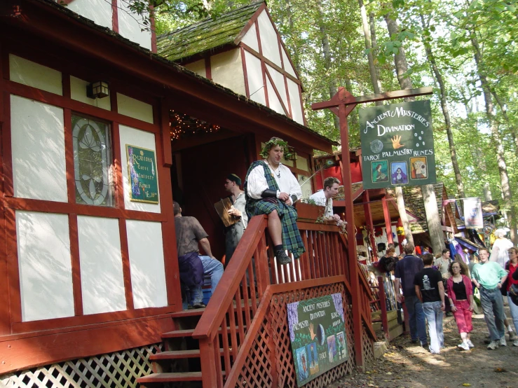 the men are standing at the entrance of the house